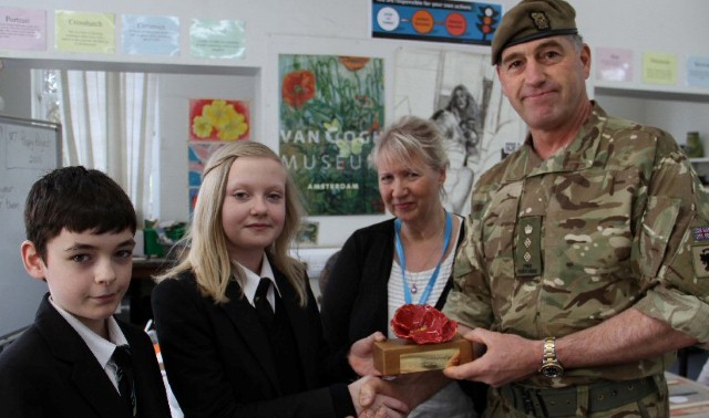 Army Colonel is presented with poppy tribute to remember