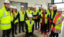 Students mark the completion of a new academy building
