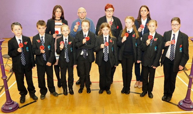 600 poppies are handed to students in special act of worship 