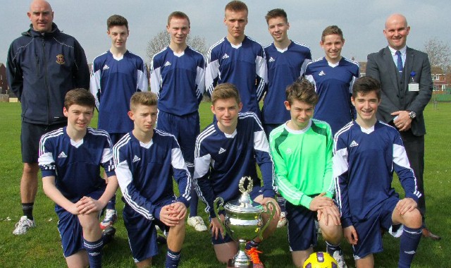 Footballers lift cup in strip dedicated to former pupil