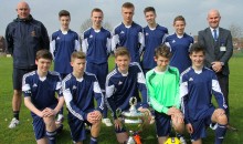 Footballers lift cup in strip dedicated to former pupil