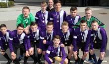 Players lift schools football trophy 